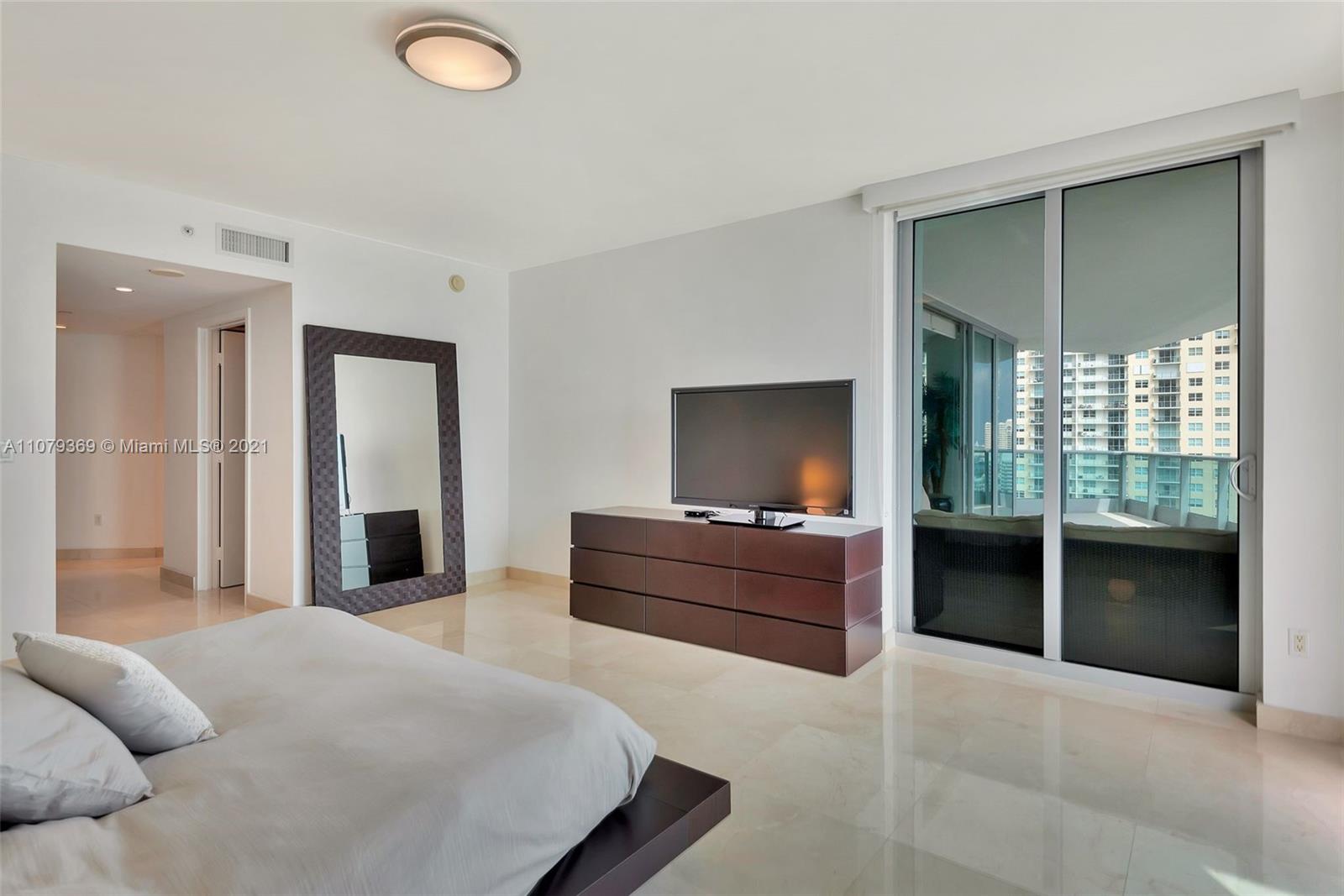 1331 Brickell Bay Drive, Unit 2401 Miami, FL 33131 - Photo 38 of 52 a bedroom with a bed and a television