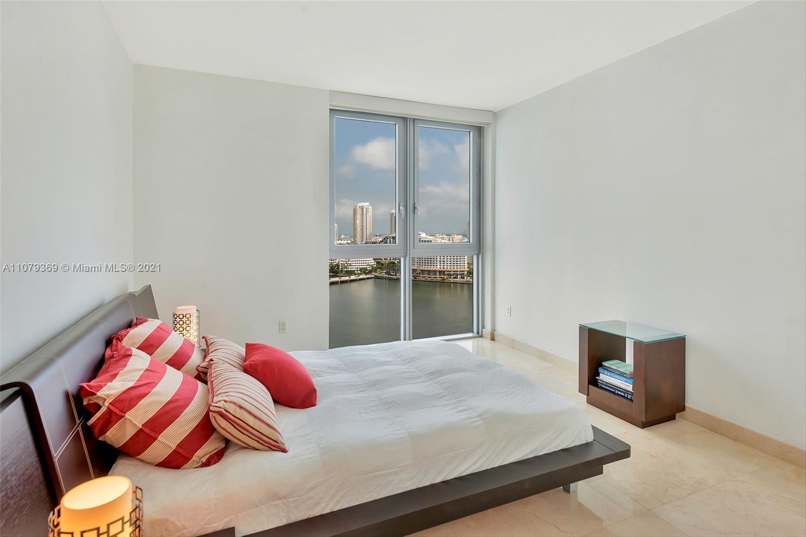 1331 Brickell Bay Drive, Unit 2401 Miami, FL 33131 - Photo 40 of 52 a bedroom with a bed and painting on the wall