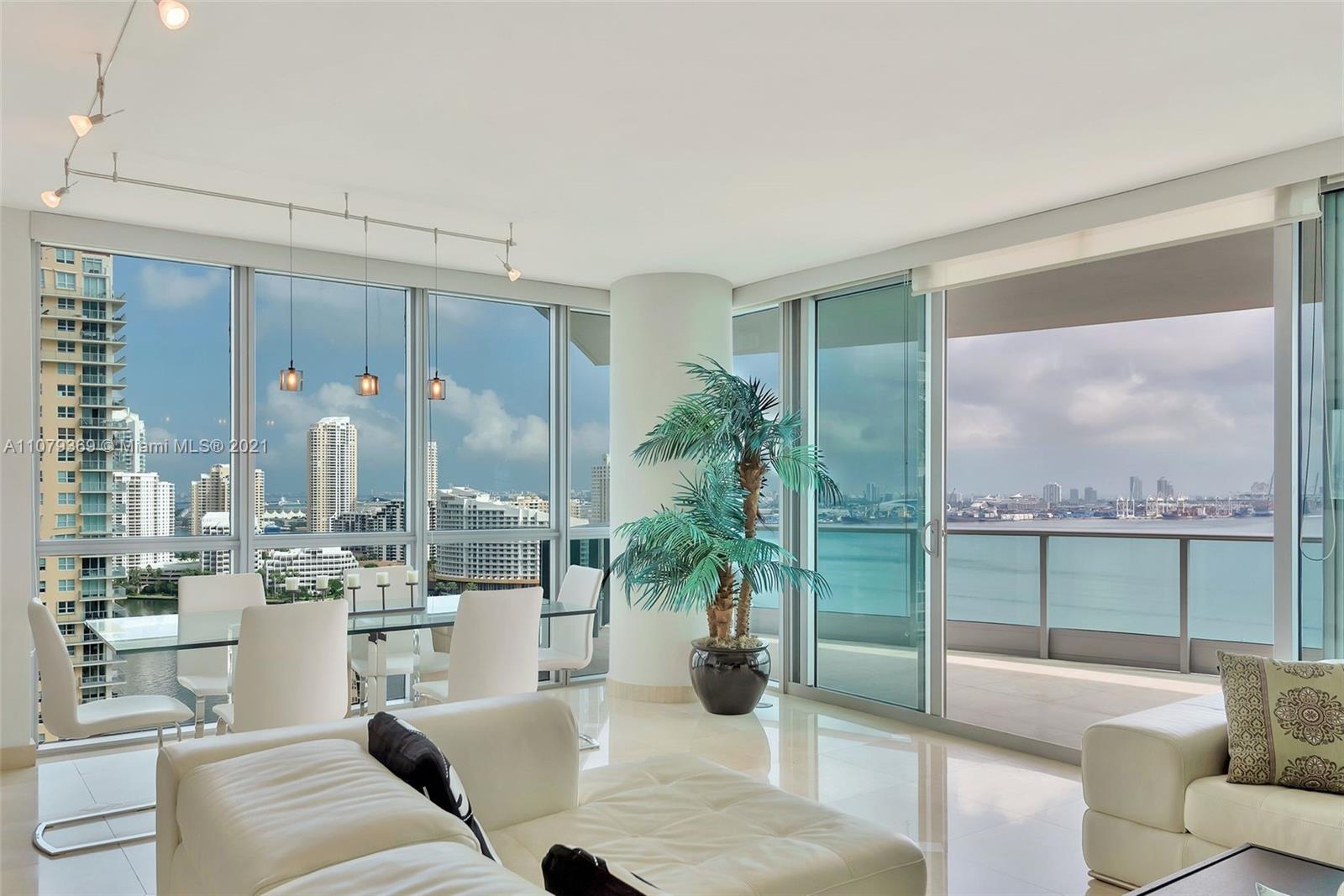 1331 Brickell Bay Drive, Unit 2401 Miami, FL 33131 - Photo 4 of 52 a living room with furniture and a floor to ceiling window