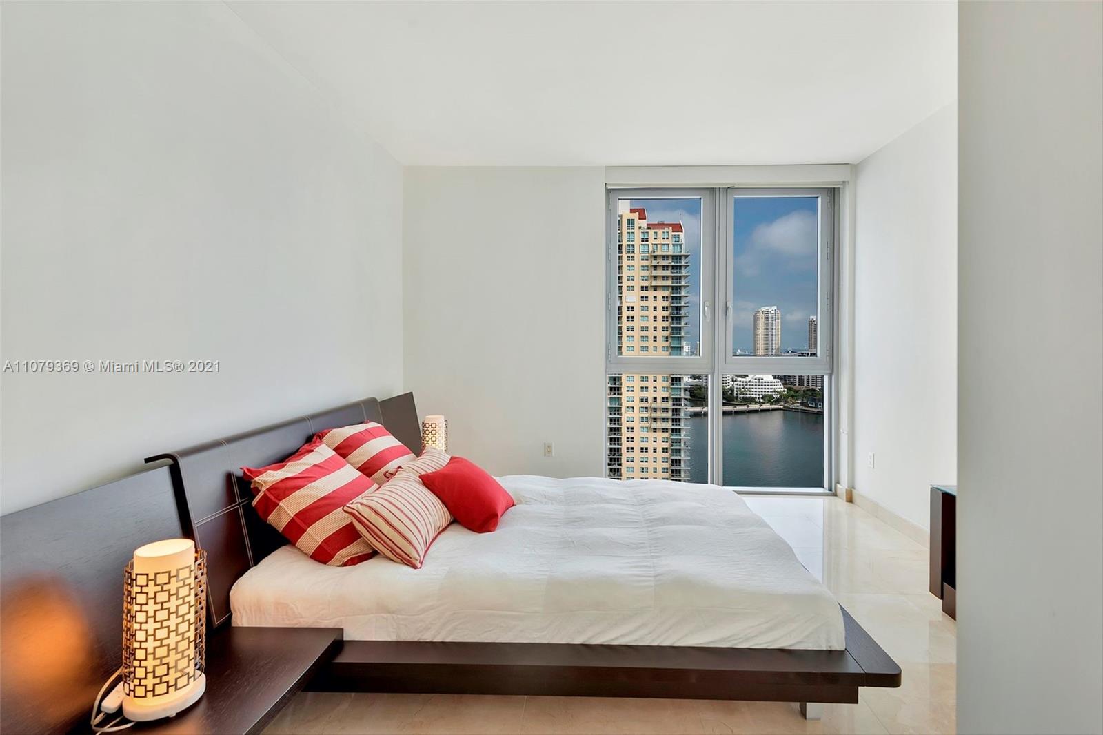 1331 Brickell Bay Drive, Unit 2401 Miami, FL 33131 - Photo 41 of 52 a bedroom with a bed and dresser