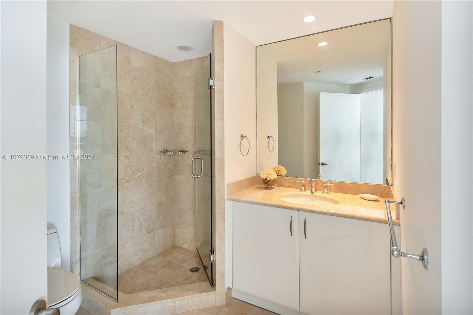 1331 Brickell Bay Drive, Unit 2401 Miami, FL 33131 - Photo 44 of 52 a bathroom with a shower and a sink