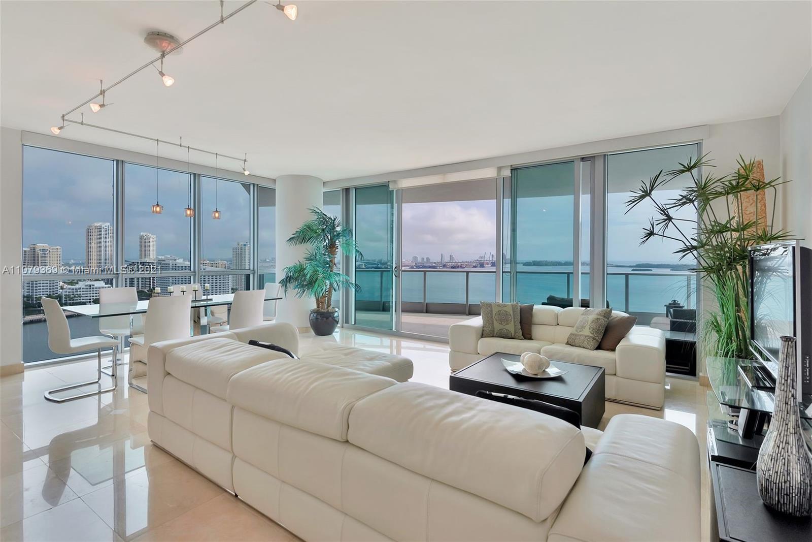 1331 Brickell Bay Drive, Unit 2401 Miami, FL 33131 - Photo 5 of 52 a living room with furniture and a large window