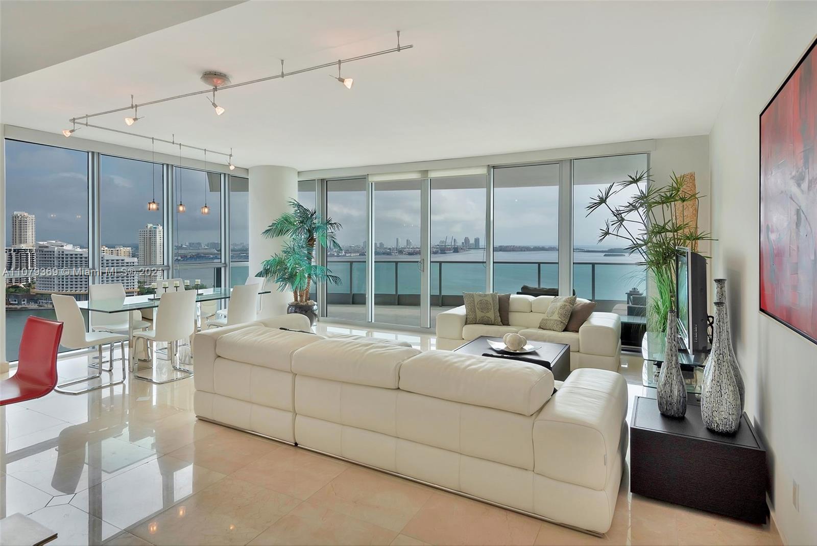 1331 Brickell Bay Drive, Unit 2401 Miami, FL 33131 - Photo 7 of 52 a living room with furniture and a large window