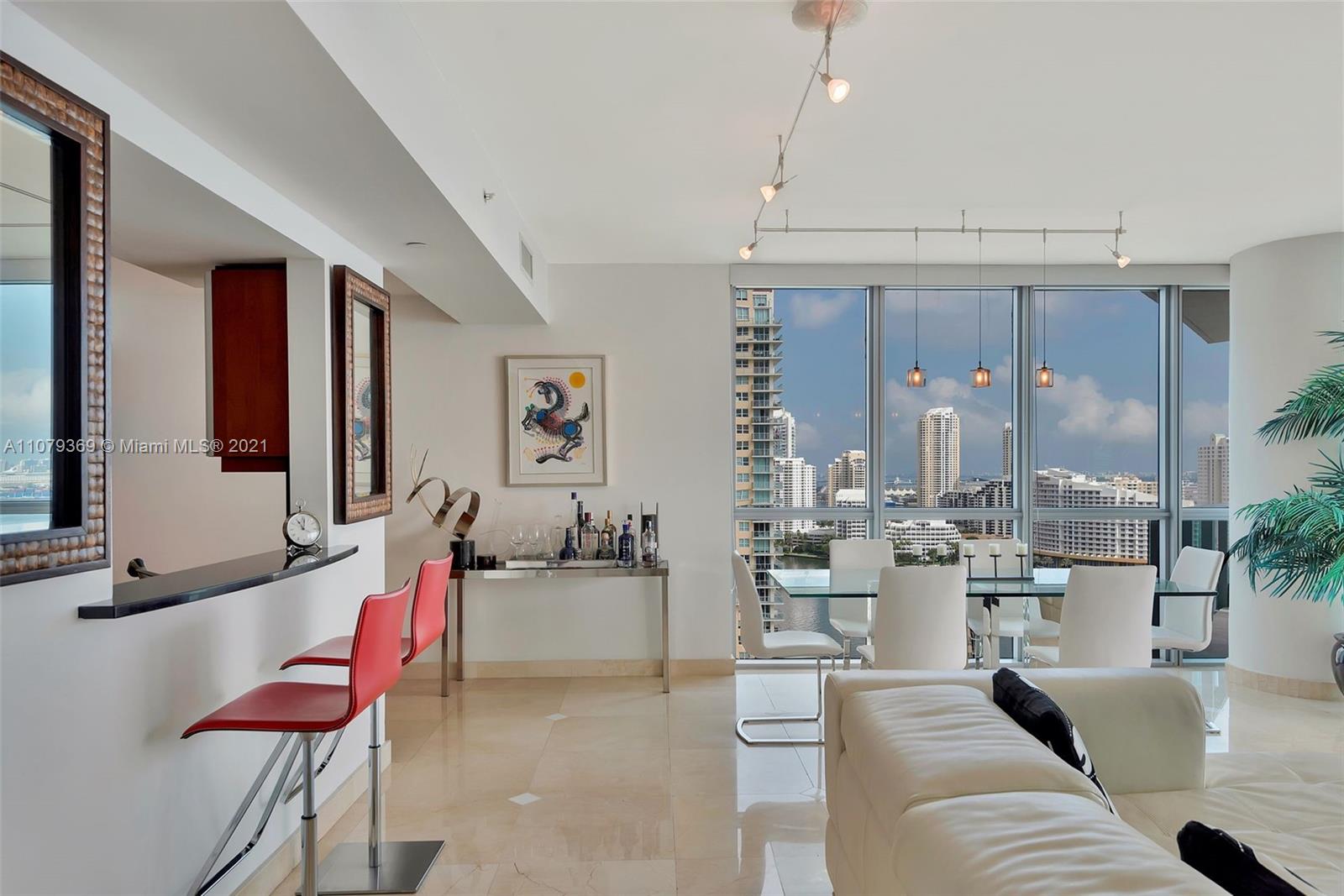 1331 Brickell Bay Drive, Unit 2401 Miami, FL 33131 - Photo 10 of 52 a living room with fireplace furniture and a large window