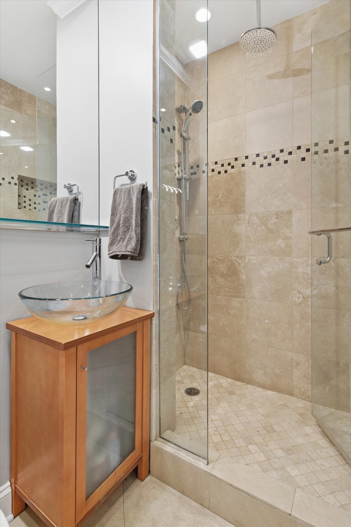 70 East Scott Street, Unit 306 Chicago, IL 60610 - Photo 13 of 17 a bathroom with a shower sink and mirror