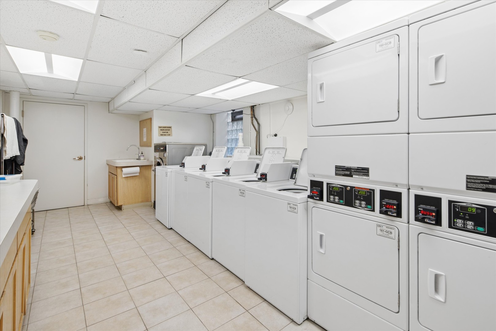 70 East Scott Street, Unit 306 Chicago, IL 60610 - Photo 14 of 17 a kitchen with cabinets and white stainless steel appliances