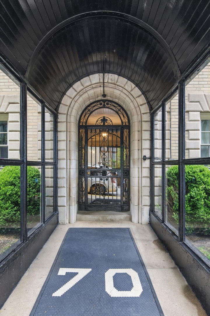 70 East Scott Street, Unit 306 Chicago, IL 60610 - Photo 2 of 17 a view of entryway with a floor to ceiling window and stairs