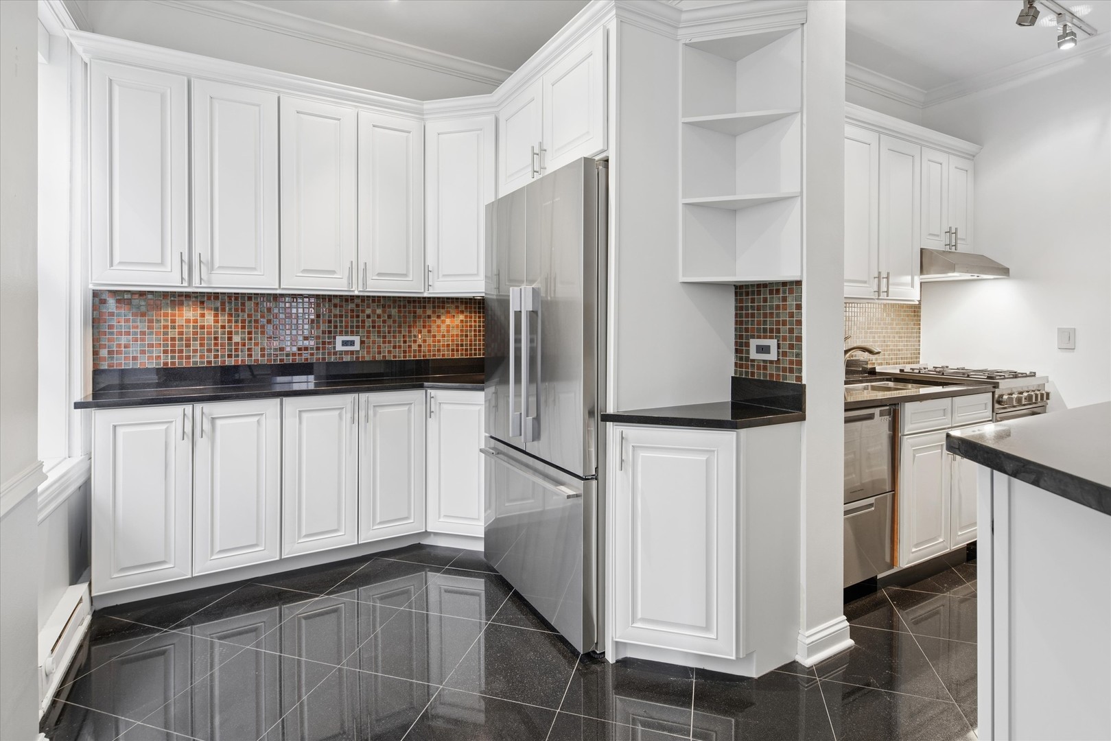 70 East Scott Street, Unit 306 Chicago, IL 60610 - Photo 7 of 17 a kitchen with stainless steel appliances white cabinets and a refrigerator