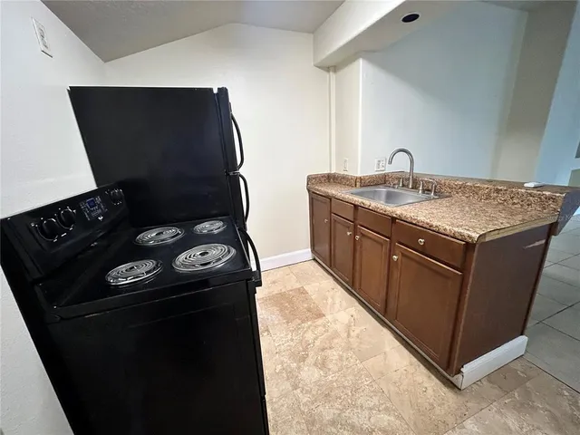 a kitchen with a stove and a refrigerator