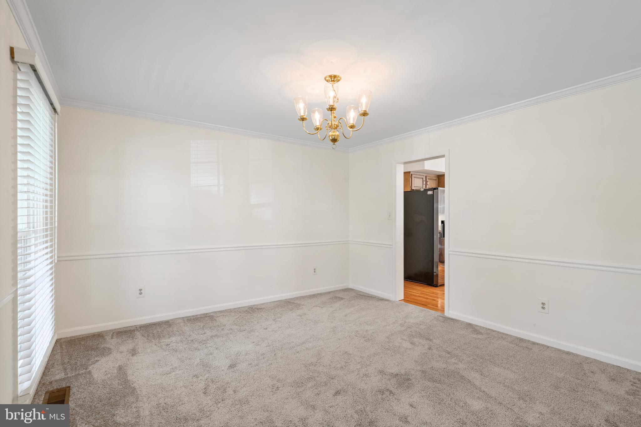6218 Stonehunt Place Clifton, VA 20124 - Photo 11 of 37 an empty room with chandelier fan and windows