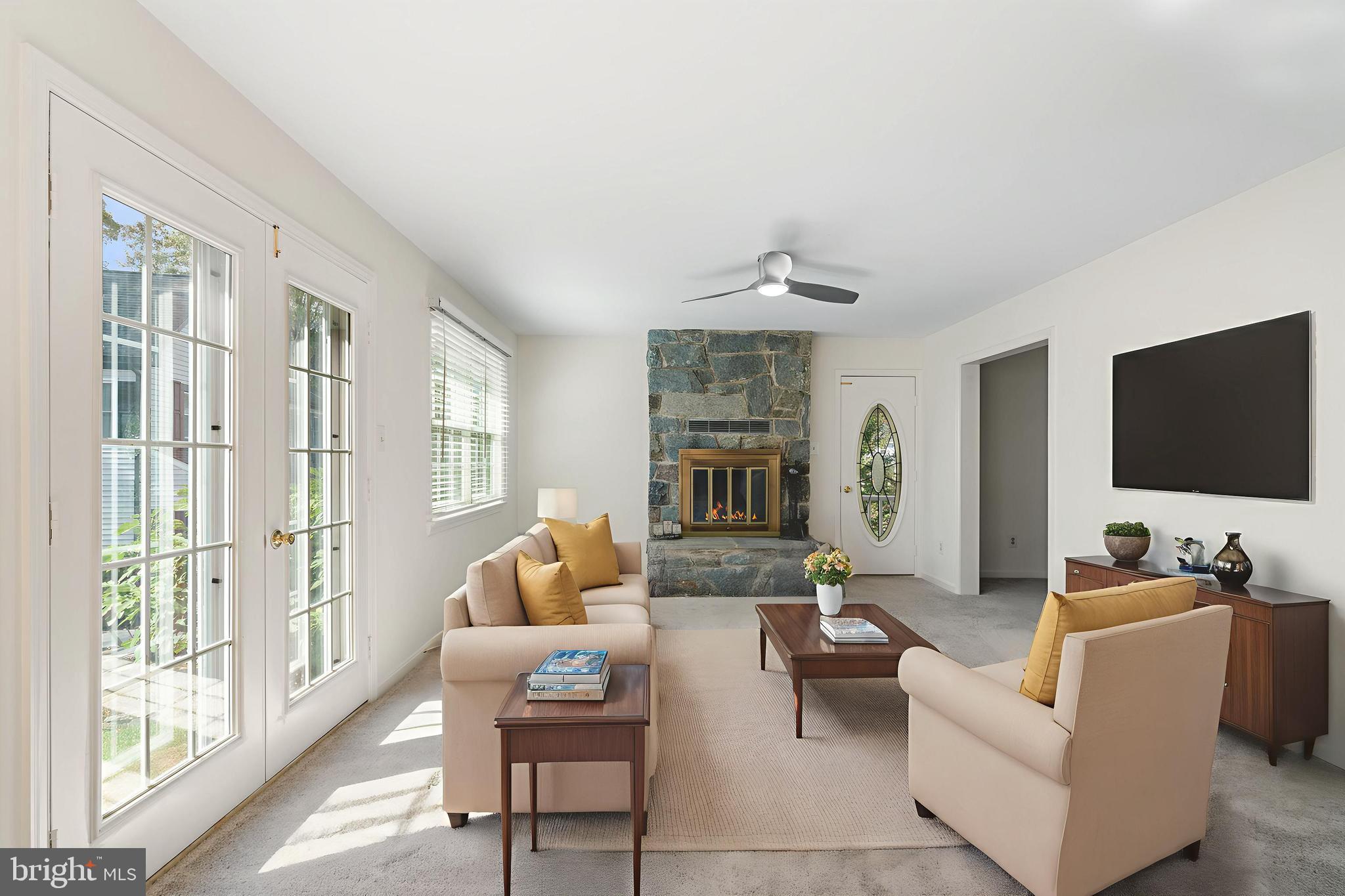 6218 Stonehunt Place Clifton, VA 20124 - Photo 14 of 37 a living room with furniture and a flat screen tv