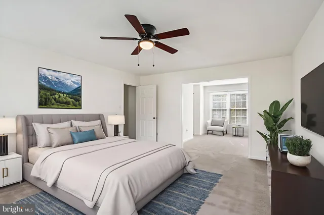 a spacious bedroom with a bed and a potted plant