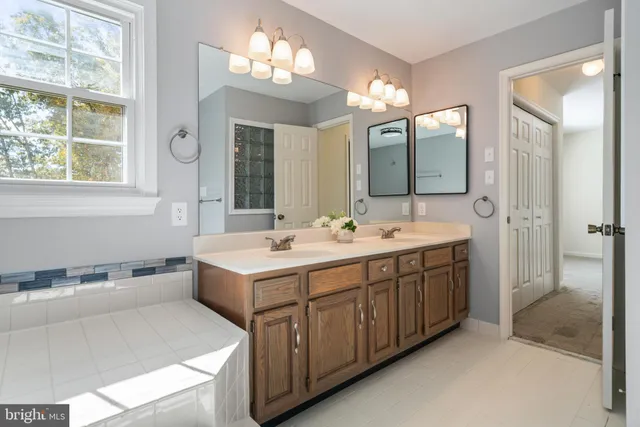 a bathroom with a sink double vanity and a mirror