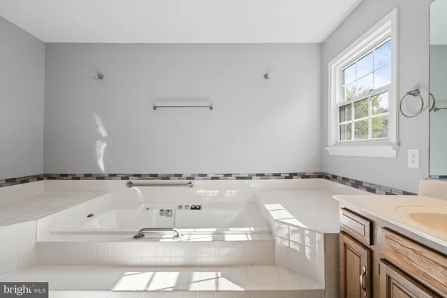 a view of a kitchen with wooden floor and a window