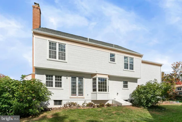 a front view of a house with a yard and potted plants