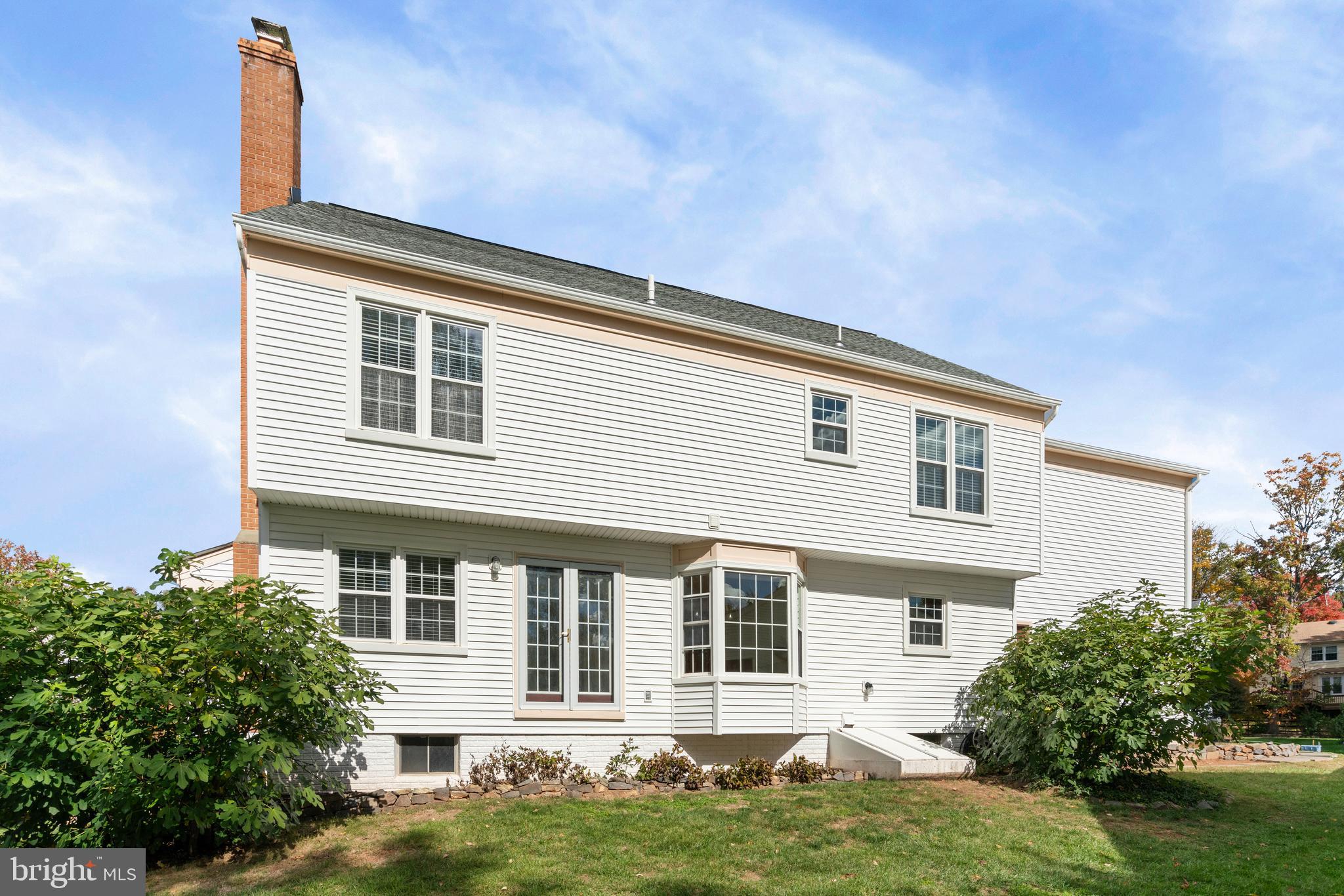 6218 Stonehunt Place Clifton, VA 20124 - Photo 34 of 37 a front view of a house with a yard and potted plants