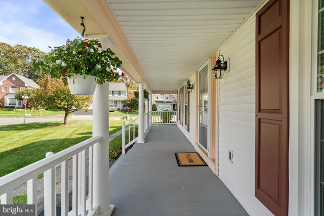 a view of a porch with furniture and garden