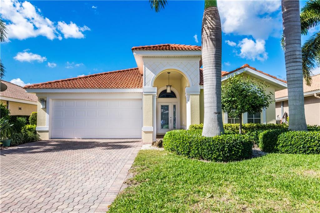 19741 Villa Rosa Loop Estero, FL 33967 - Photo 1 of 21 a front view of a house with a garden