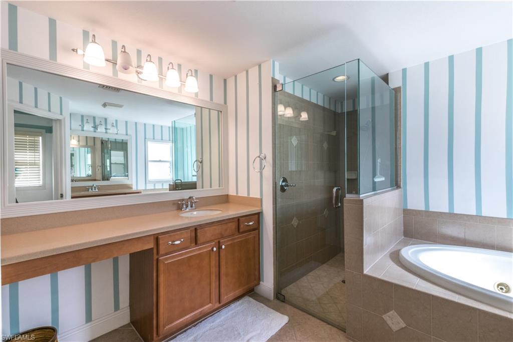 19741 Villa Rosa Loop Estero, FL 33967 - Photo 13 of 21 a bathroom with a double vanity sink toilet and shower