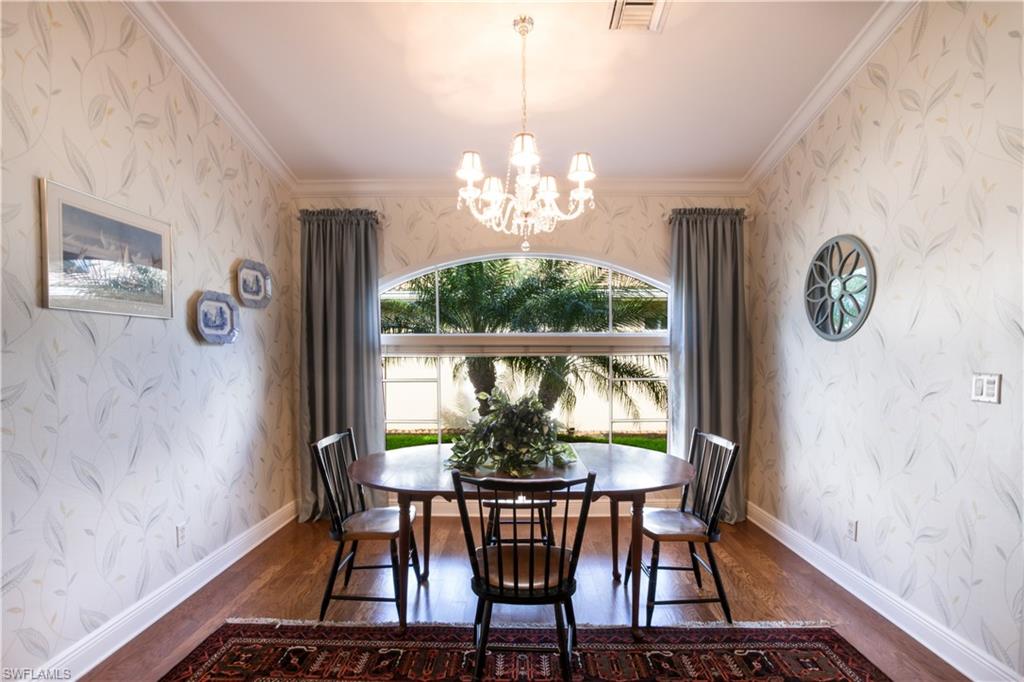 19741 Villa Rosa Loop Estero, FL 33967 - Photo 5 of 21 a view of a dining room with furniture a chandelier and wooden floor
