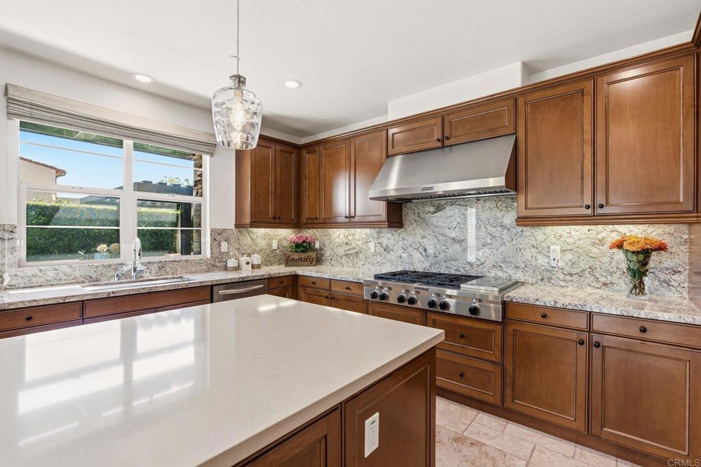 809 Dolphin Circle Encinitas, CA 92024 - Photo 32 of 71 a kitchen with granite countertop a sink a counter space appliances and cabinets
