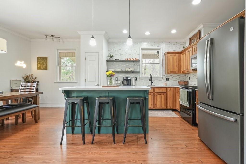 2232 Burnt Mountain Road Jasper, GA 30143 - Photo 17 of 50 a kitchen with stainless steel appliances granite countertop a refrigerator a sink dishwasher a stove and white cabinets with wooden floor