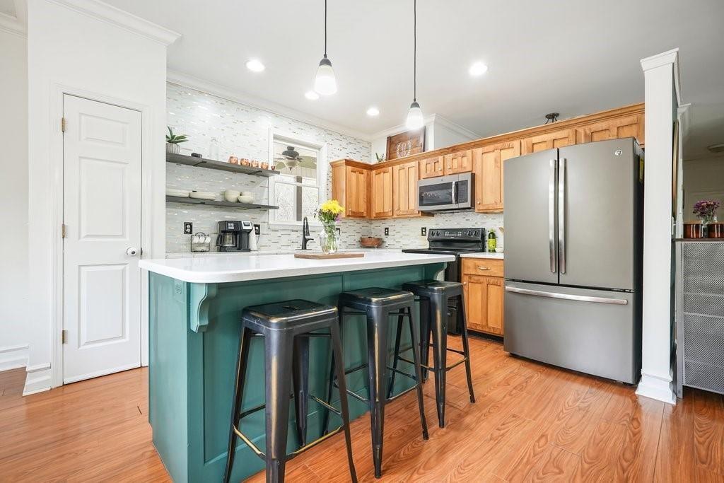 2232 Burnt Mountain Road Jasper, GA 30143 - Photo 18 of 50 a kitchen with stainless steel appliances granite countertop a refrigerator a sink dishwasher a stove and white cabinets with wooden floor