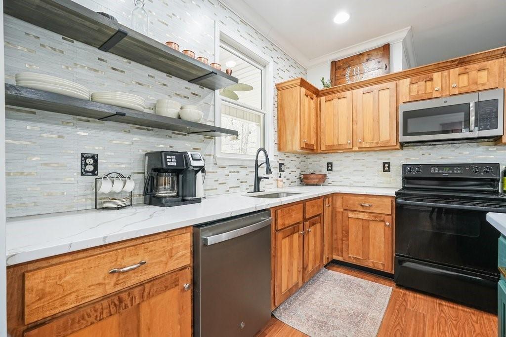 2232 Burnt Mountain Road Jasper, GA 30143 - Photo 19 of 50 a kitchen with stainless steel appliances granite countertop wooden cabinets a sink and a stove