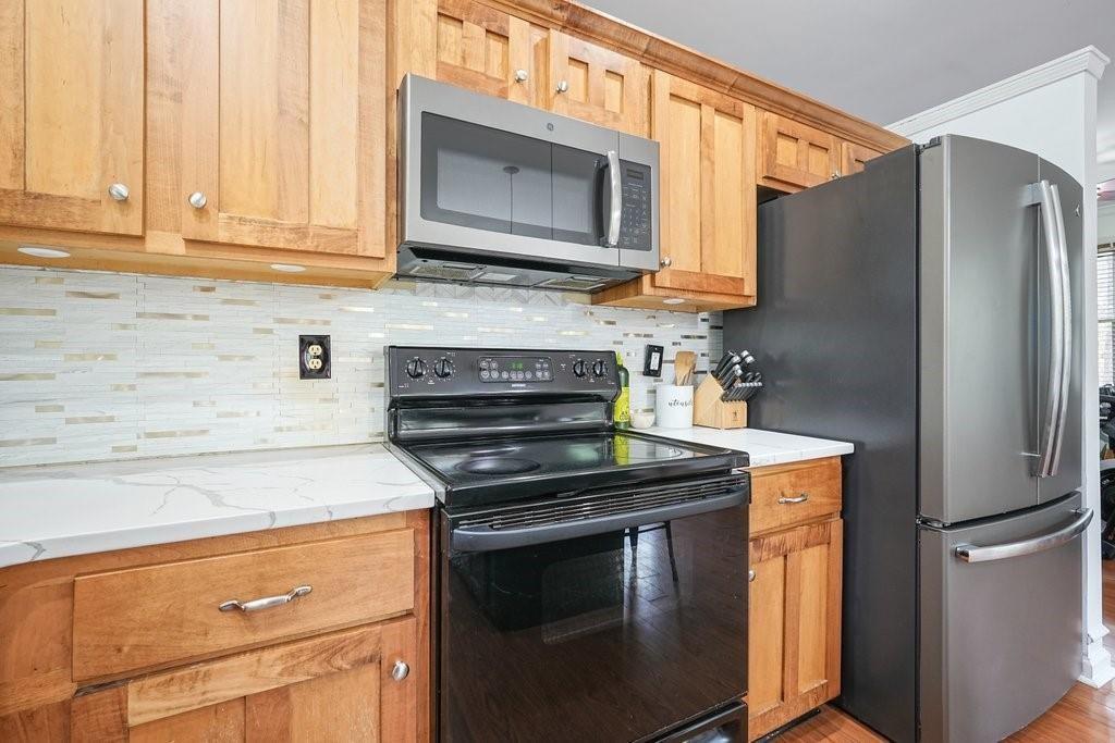 2232 Burnt Mountain Road Jasper, GA 30143 - Photo 20 of 50 a kitchen with stainless steel appliances granite countertop a refrigerator stove and microwave