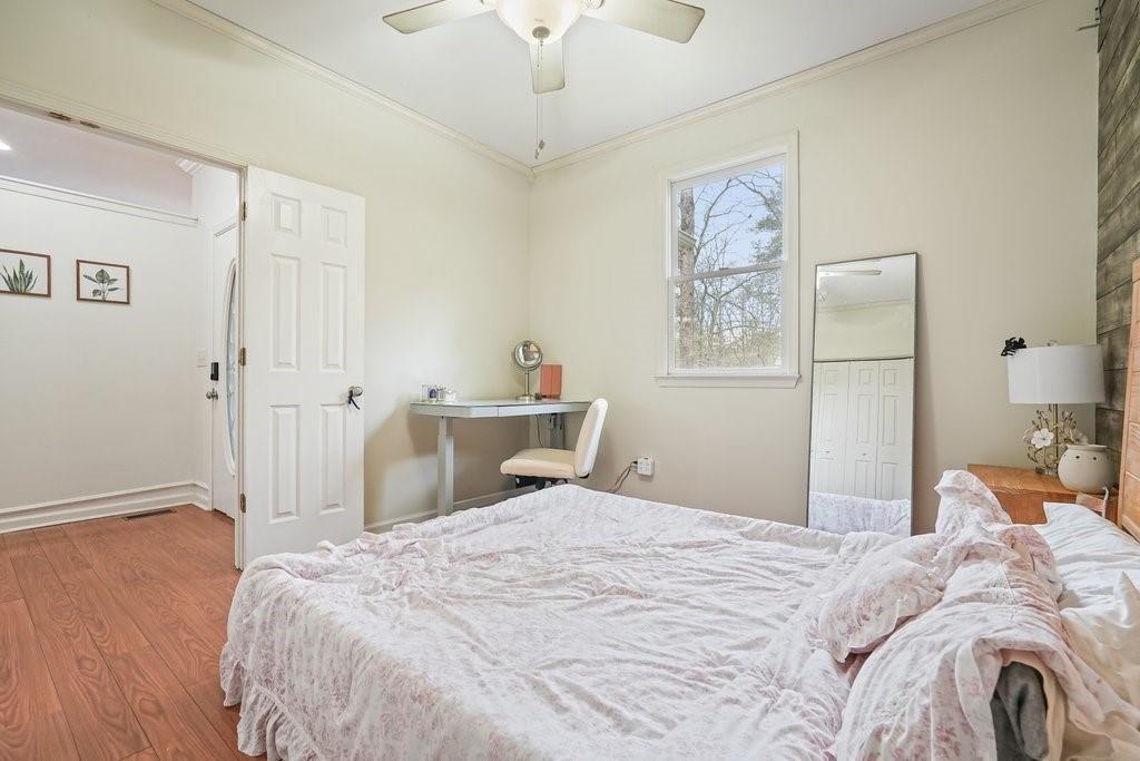 2232 Burnt Mountain Road Jasper, GA 30143 - Photo 26 of 50 a bedroom with a bed and a chandelier