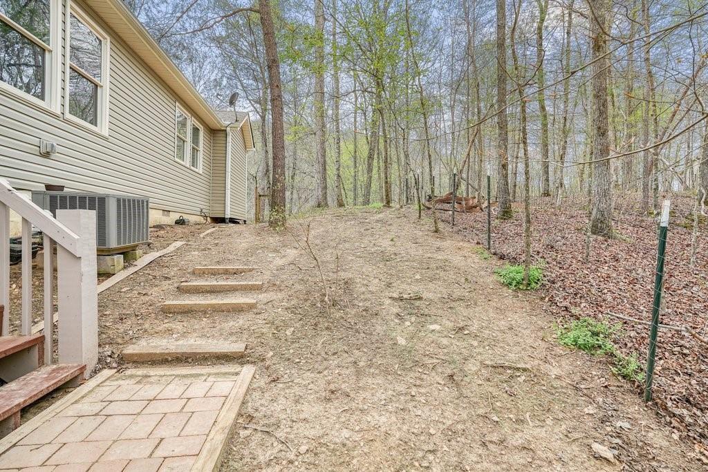 2232 Burnt Mountain Road Jasper, GA 30143 - Photo 45 of 50 a backyard of a house with lots of green space