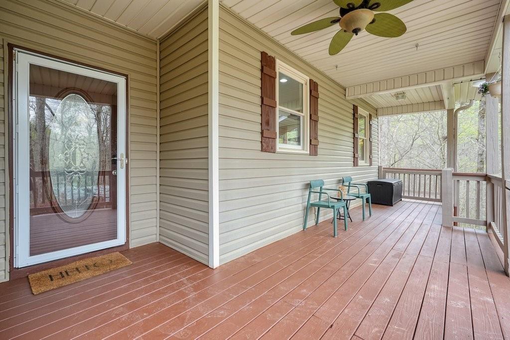 2232 Burnt Mountain Road Jasper, GA 30143 - Photo 10 of 50 a view of a deck with wooden floor and a table