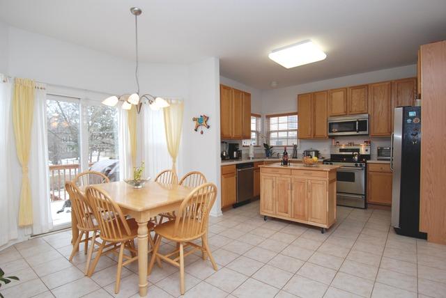 231 South Quentin Road Palatine, IL 60067 - Photo 4 of 10 a kitchen with a dining table chairs stainless steel appliances and cabinets