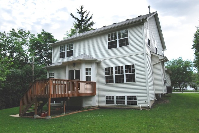 231 South Quentin Road Palatine, IL 60067 - Photo 9 of 10 a front view of a house with a garden