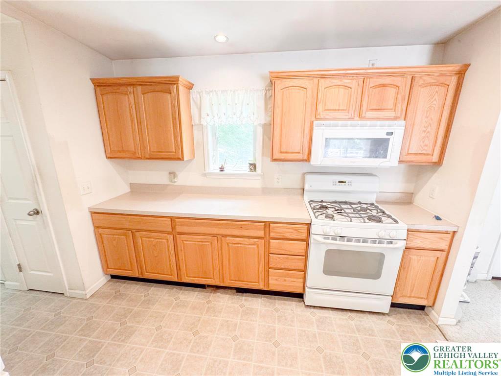 111 Turkey Ridge Kunkletown, PA 18058 - Photo 9 of 30 a kitchen with granite countertop a sink and a stove top oven