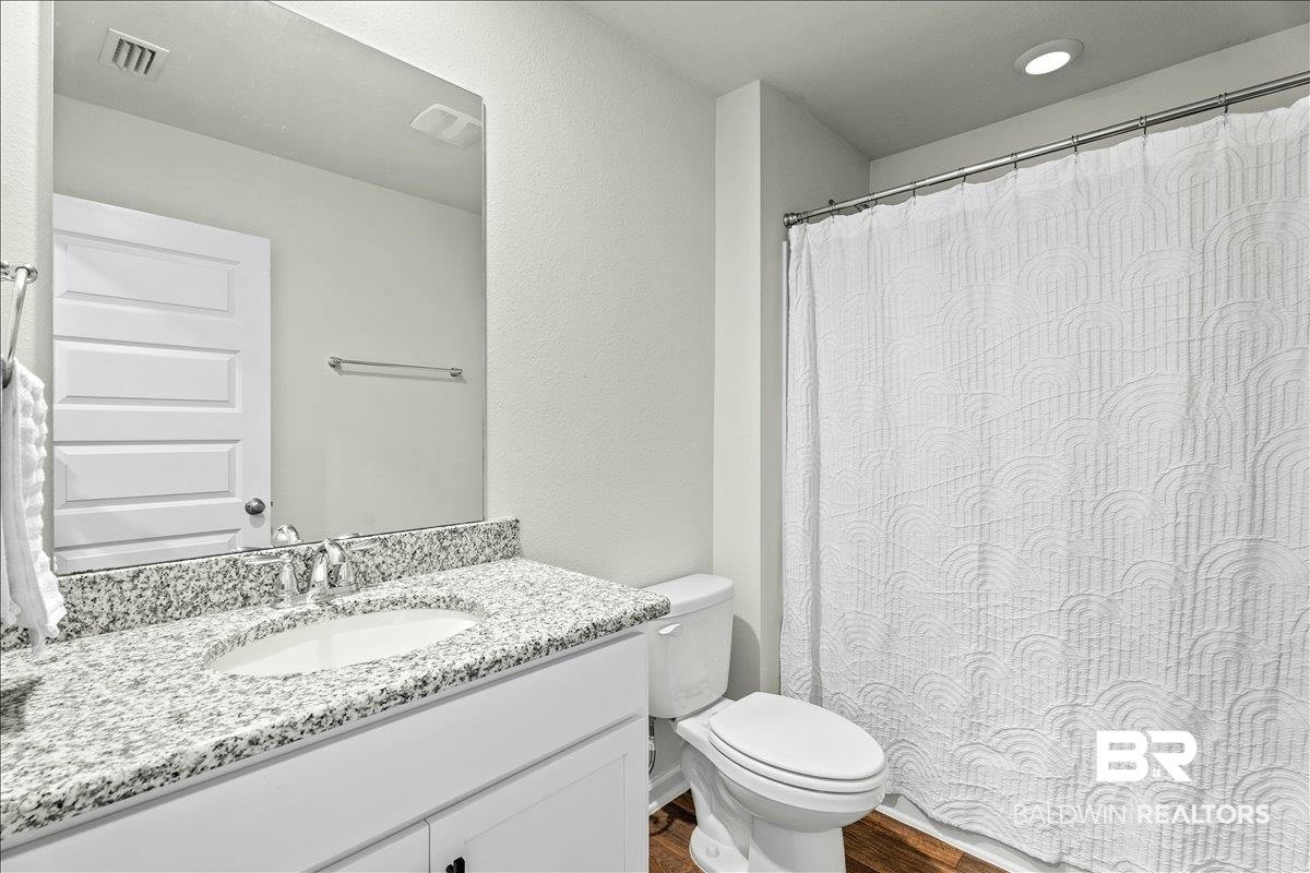 23641 Unbridled Loop Daphne, AL 36526 - Photo 25 of 40 Bathroom featuring a white vanity with a granite countertop and an undermount sink