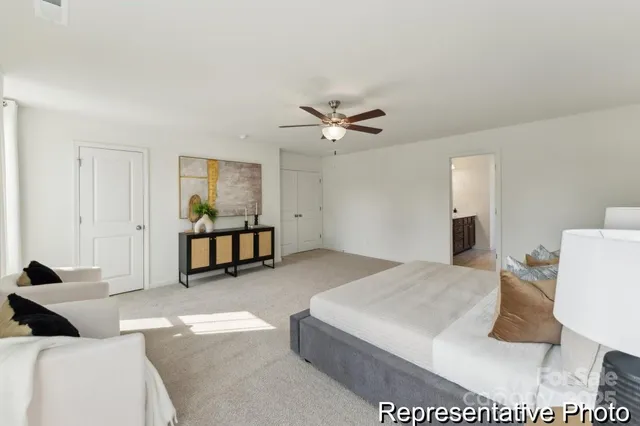 a living room with furniture and a ceiling fan