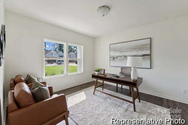 a living room with furniture a window and a table
