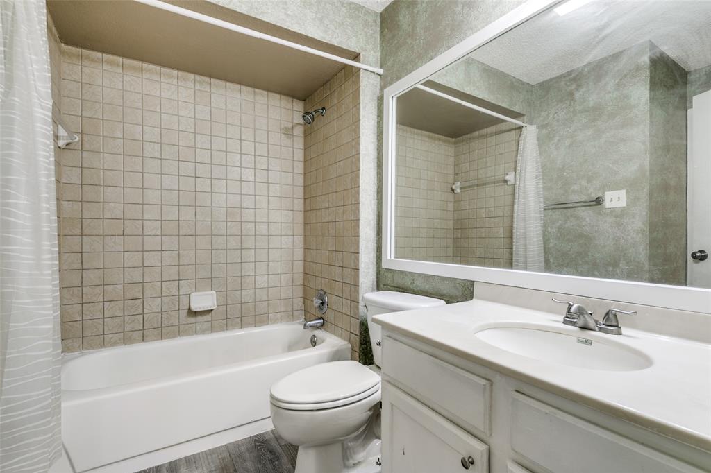2400 Jupiter Road, Unit 2 Plano, TX 75074 - Photo 12 of 18 a bathroom with a bathtub shower sink vanity mirror and toilet