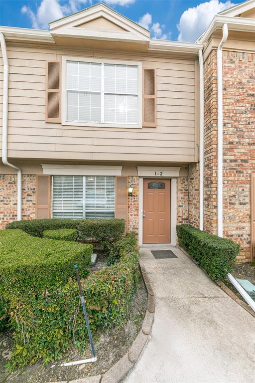 2400 Jupiter Road, Unit 2 Plano, TX 75074 - Photo 2 of 18 a front view of a house with a garden