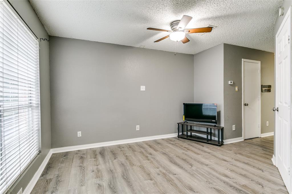 2400 Jupiter Road, Unit 2 Plano, TX 75074 - Photo 4 of 18 a view of room with wooden floor and ceiling fan