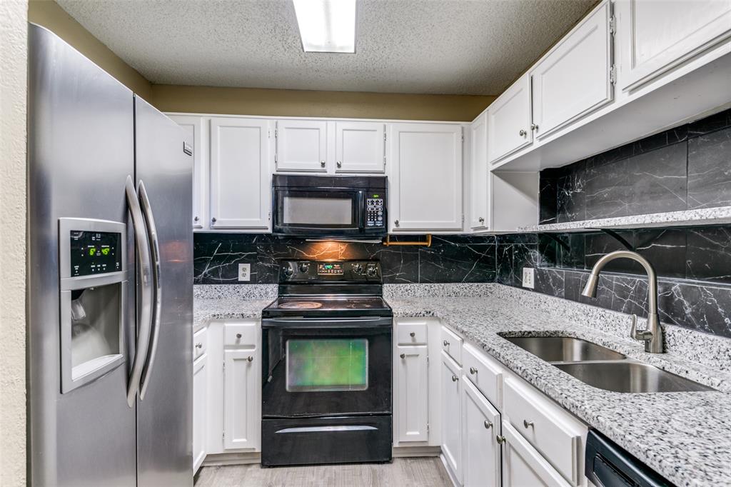 2400 Jupiter Road, Unit 2 Plano, TX 75074 - Photo 6 of 18 a kitchen with stainless steel appliances granite countertop a refrigerator sink and stove