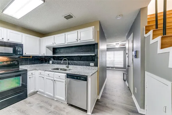 a kitchen with a sink stove and refrigerator