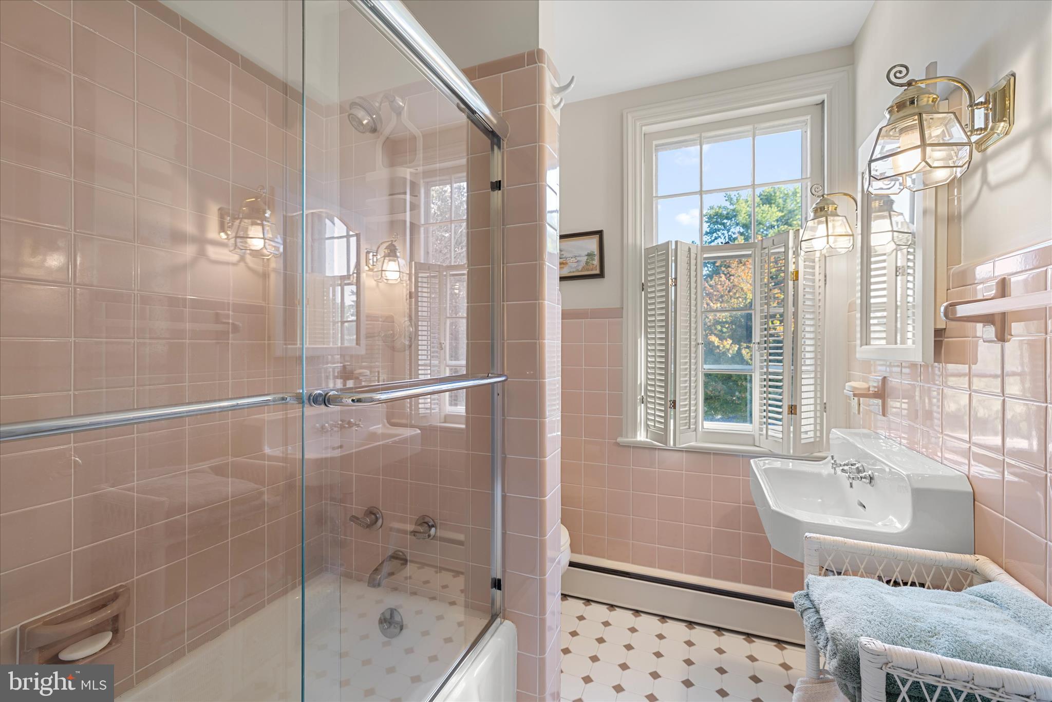 27473 Westpoint Road Easton, MD 21601 - Photo 28 of 58 a bathroom with a bathtub shower and windows