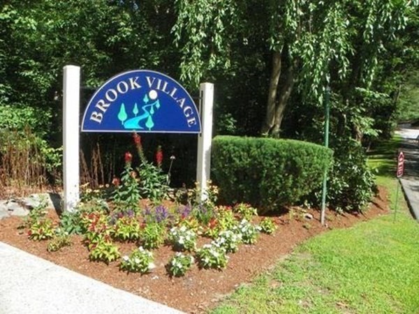 23 Spencer Road, Unit 22F Boxborough, MA 01719 - Photo 10 of 10 a sign that is sitting in front of flowers