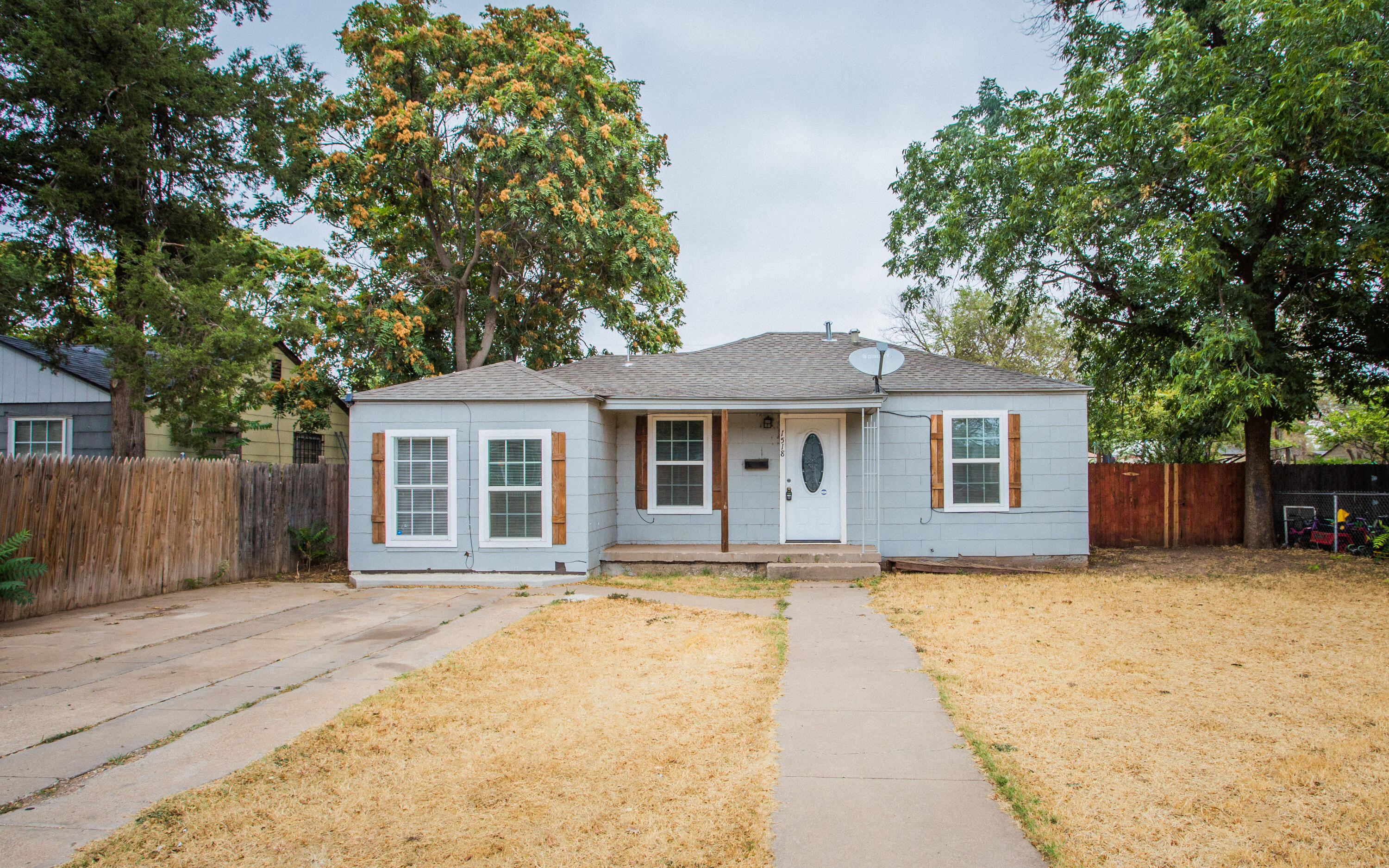 1518 40th Street Lubbock, TX 79412 - Photo 1 of 13 a front view of house with yard and trees around