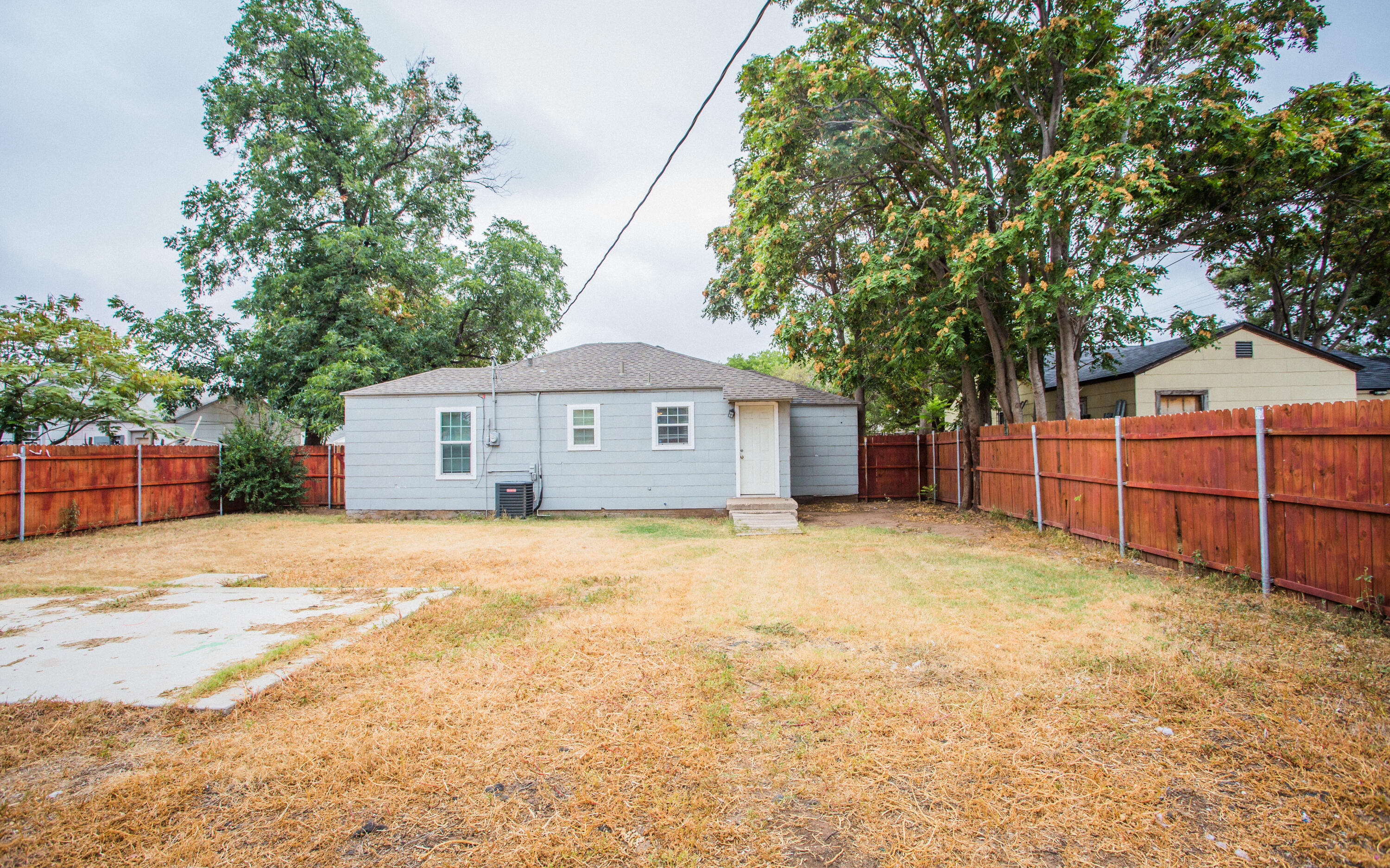 1518 40th Street Lubbock, TX 79412 - Photo 13 of 13 a front view of a house with a yard and garage