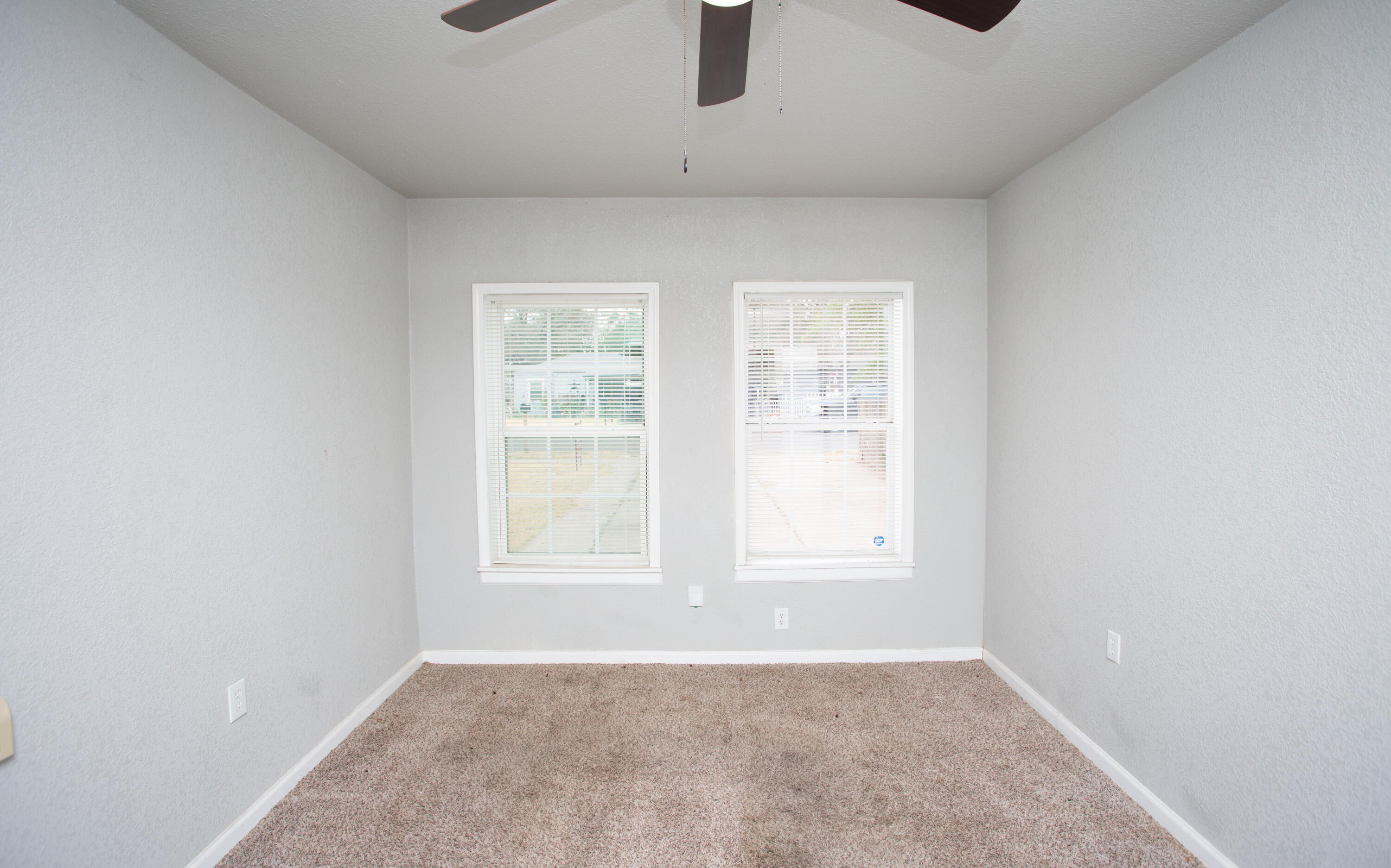 1518 40th Street Lubbock, TX 79412 - Photo 6 of 13 an empty room with windows