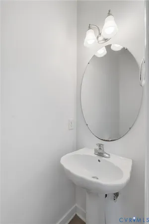 a bathroom with a sink a mirror and vanity