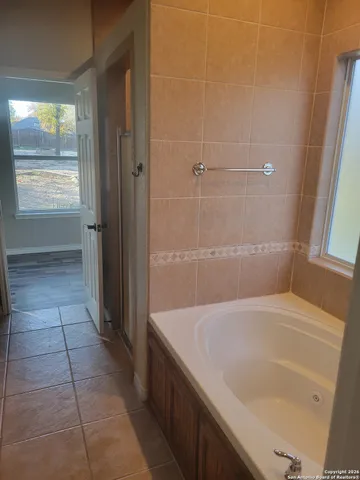 a bathroom with a tub and shower